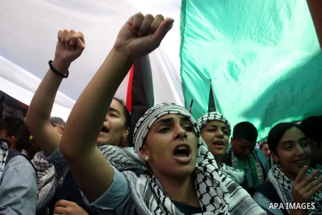 Palestinians participate in a rally in support of the Palestinian bid for statehood recognition in the United Nations, in the West Bank city of Ramallah, Wednesday, Sept. 21, 2011. Thousands of flag-waving Palestinians r...