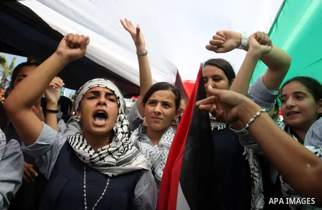 Palestinians participate in a rally in support of the Palestinian bid for statehood recognition in the United Nations, in the West Bank city of Ramallah, Wednesday, Sept. 21, 2011. Thousands of flag-waving Palestinians r...