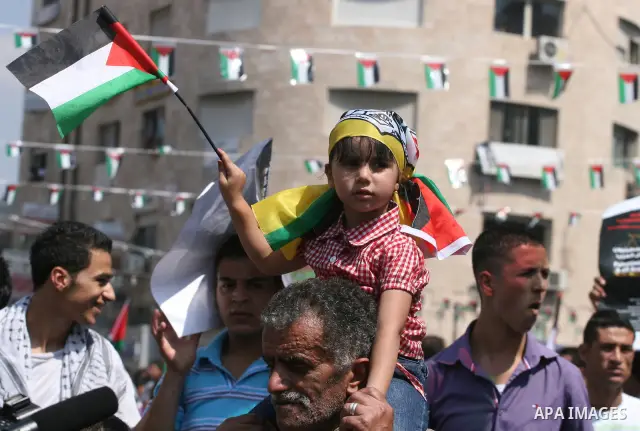 Palestinians participate in a rally in support of the Palestinian bid for statehood recognition in the United Nations, in the West Bank city of Ramallah, Wednesday, Sept. 21, 2011. Thousands of flag-waving Palestinians r...
