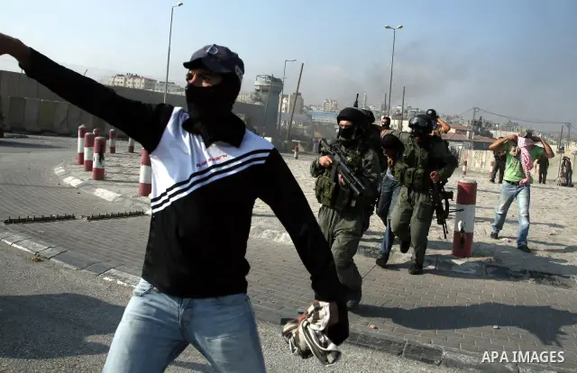 Undercover Israeli police and border police officers arrest Palestinian demonstrators during clashes with the Israeli military at the Qalandia checkpoint between the West Bank city of Ramallah and Jerusalem, Wednesday, S...