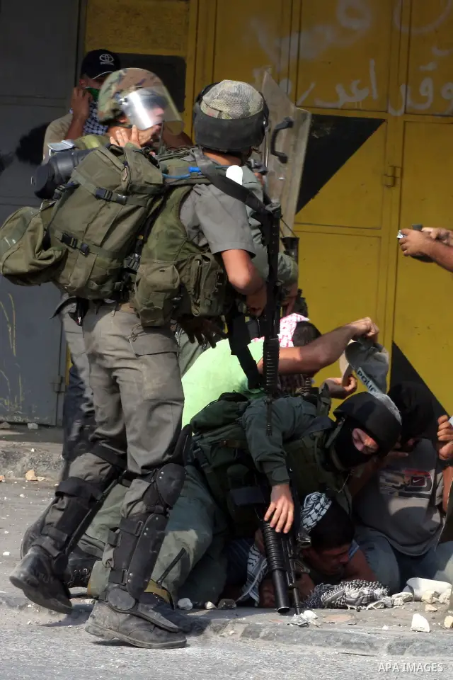 Undercover Israeli police and border police officers arrest Palestinian demonstrators during clashes with the Israeli military at the Qalandia checkpoint between the West Bank city of Ramallah and Jerusalem, Wednesday, S...