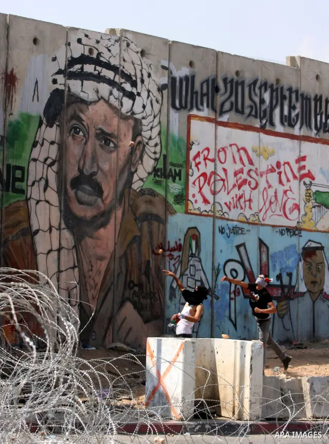 Palestinian protesters throw stones at Israeli soldiers during clashes at the Qalandia checkpoint between the West Bank city of Ramallah and Jerusalem, Wednesday, Sept. 21, 2011. Palestinians clashed with Israeli securit...