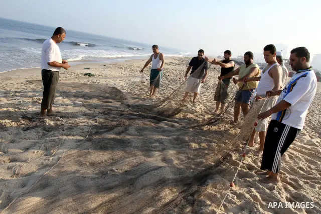 Palestinian fishermen prepare their nets for fishing at the beach of Gaza city on Sep. 22, 2011. Palestinians hoped that the blockade is lifted from the sea, and setting "Palestine state 194", representing their hope to...