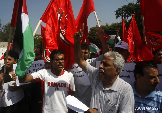 Palestinians chant slogans and wave their national flag during a demonstration in support of Palestinian leader Mahmud Abbas' bid for statehood recognition at the United Nations on September 22, 2011 in Gaza City. Photo...