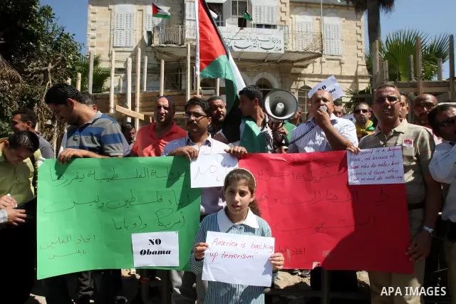Palestinians hold up signs against US President Barack Obama during a protest in the northern West Bank city of Nablus on September 22, 2011. Palestinians slammed US President Barack Obama's United Nations address a day...