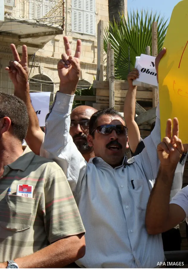 Palestinians hold up signs against US President Barack Obama during a protest in the northern West Bank city of Nablus on September 22, 2011. Palestinians slammed US President Barack Obama's United Nations address a day...