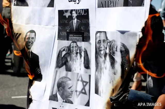 Palestinians burn manipulated pictures of US President Barack Obama during an anti U.S. demonstration in the West Bank city of Ramallah, Thursday, Sept. 22, 2011. Palestinian protesters have denounced President Barack Ob...