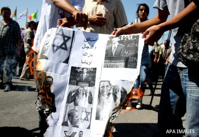 Palestinians burn manipulated pictures of US President Barack Obama during an anti U.S. demonstration in the West Bank city of Ramallah, Thursday, Sept. 22, 2011. Palestinian protesters have denounced President Barack Ob...