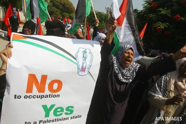 Palestinian women chant slogans and wave their national flag during a demonstration in support of Palestinian leader Mahmud Abbas' bid for statehood recognition at the United Nations on September 22, 2011 in Gaza City. P...
