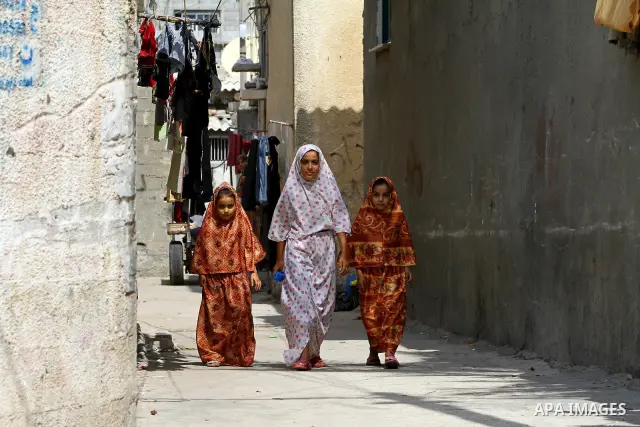 Palestinian girls stand in an alley at the al-Shati refugee camp in Gaza City on September 23, 2011. Photo by Ashraf Amra