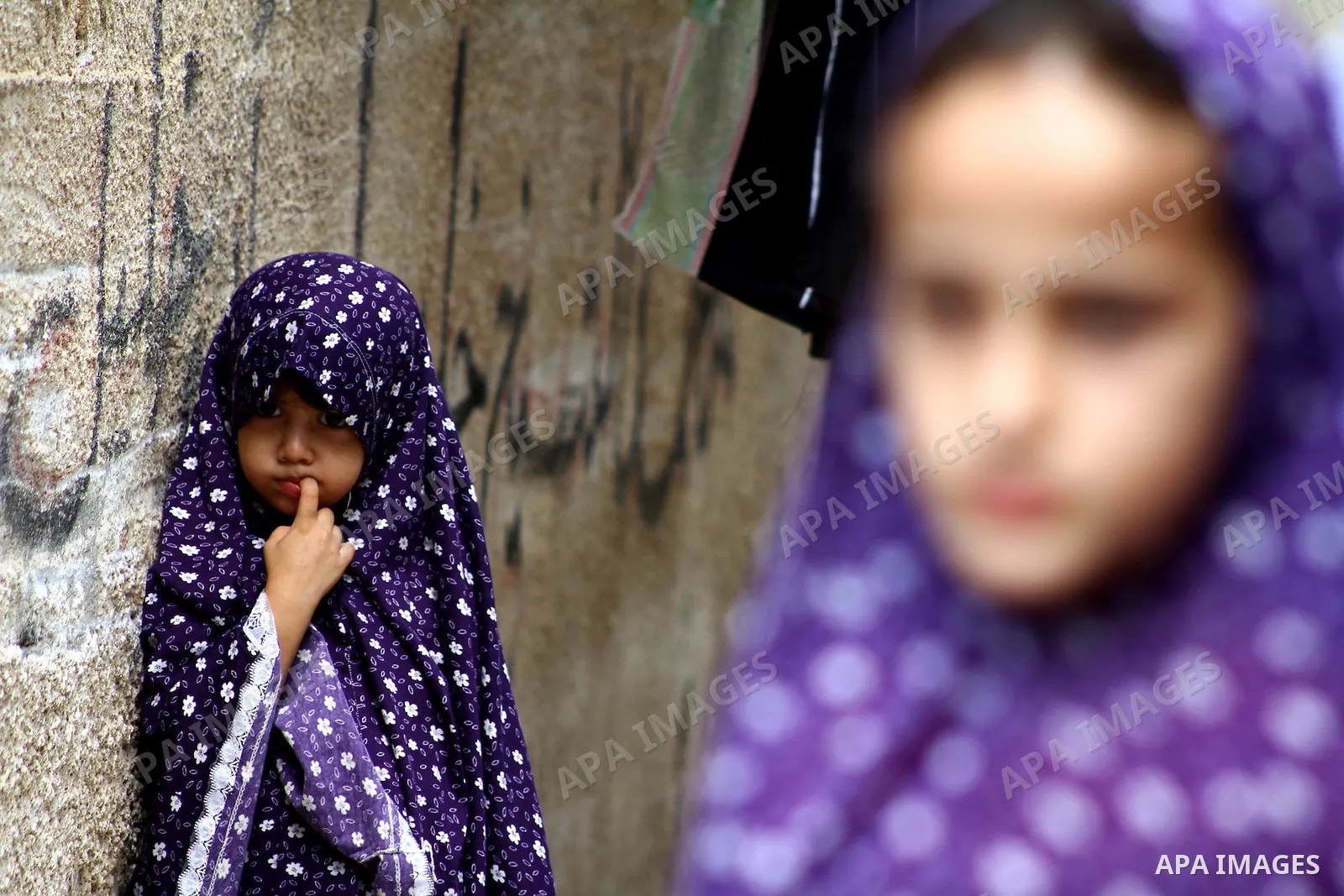 Palestinian girls stand in an alley at the al-Shati refugee camp in Gaza City on September 23, 2011. Photo by Ashraf Amra