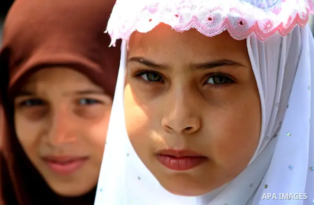 Palestinian girls stand in an alley at the al-Shati refugee camp in Gaza City on September 23, 2011. Photo by Ashraf Amra