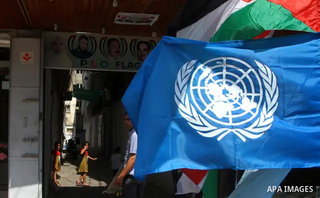 Palestinians walks front a souvenir shop in Gaza City September 21, 2011. Palestinian President Mahmoud Abbas plans on Friday to submit an application for full U.N. membership for the state of Palestine based in the West...