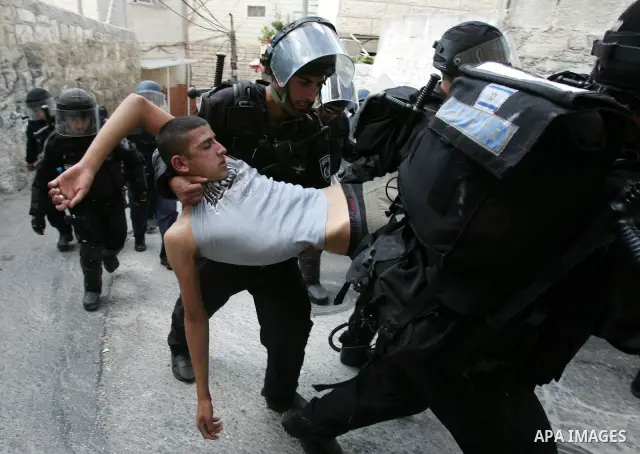 Israeli border police arrest a Palestinian youth for throwing stones at their checkpoint in Ras al-Amud neighborhood of East Jerusalem, Friday Sept. 23, 2011, just hours before their president, Mahmoud Abbas, was to deli...