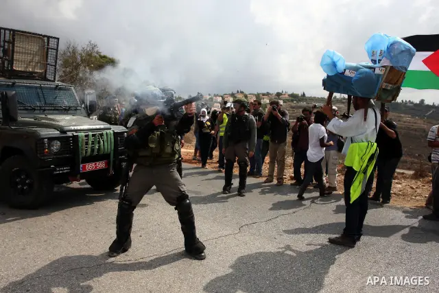 Israeli soldiers fire teargas during a clash with Palestinians in at a weekly protest in the West Bank village of Nabi Saleh, near Ramallah September 23, 2011. Israeli security forces were on high alert after Friday pray...