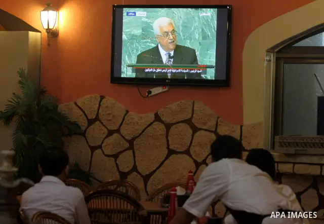 Palestinians watch the President Mahmoud Abbas on TV as he addresses the General Assembly of the United Nations at a coffee shop in Gaza city Friday, Sept. 23, 2011. Photo by Mohammed Asad