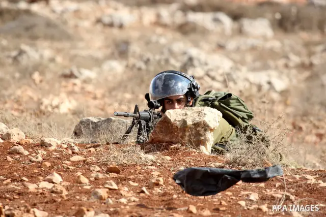 Israeli troops clash with Palestinian stone throwers in the West Bank village of Qusra, south of Nablus, on September 23, 2011. A Palestinian man was shot dead by Israeli troops in clashes which erupted after settlers at...