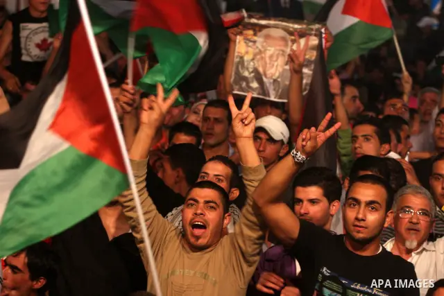 Palestinians attend a public screening of Palestinian President Mahmoud Abbas' speech at the United Nations, in the West Bank city of Ramallah September 23, 2011. Abbas asked the United Nations on Friday to recognize a s...