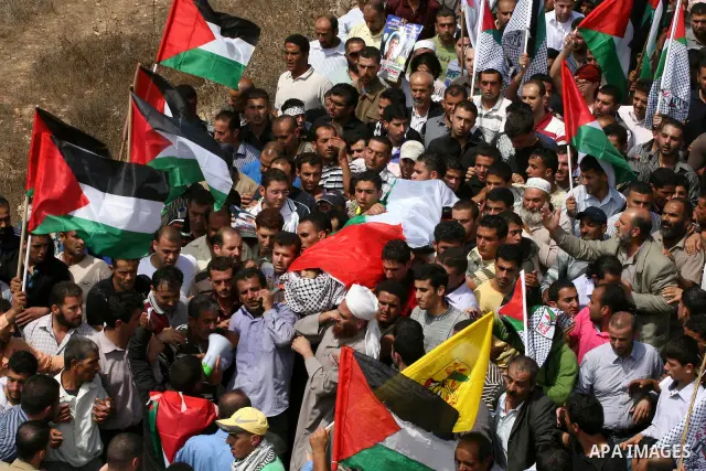 Palestinian mourners carry the body of Issam Badran during his funeral in the West Bank village of Qusra near Nablus, on Sept. 24, 2011. The 37-year-old Issam Badran was wounded by Israeli forces during a demonstration i...