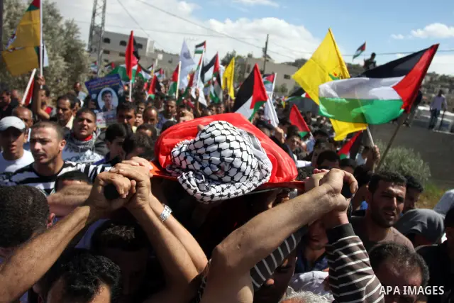 Palestinian mourners carry the body of Issam Badran during his funeral in the West Bank village of Qusra near Nablus, on Sept. 24, 2011. The 37-year-old Issam Badran was wounded by Israeli forces during a demonstration i...