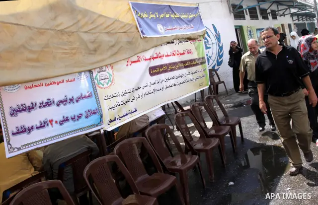 Members of the Palestinian Commissions for Refugees take part in a protest against the UNRWA to stop the work of one staff, in Gaza city on Sep. 25, 2011. Photo by Mohammed Asad