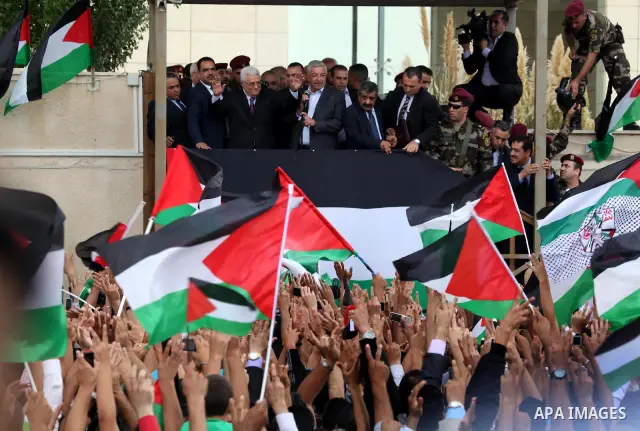 Palestinian President Mahmoud Abbas (Abo Mazen) addresses the crowd during a celebration in the West Bank city of Ramallah upon his return from the U.N. General Assembly in the U.S., on Sept. 25, 2011. Palestinians want...
