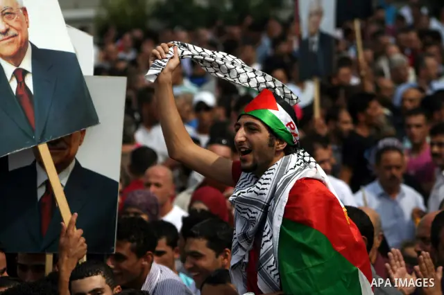 Thousands of cheering Palestinians welcome their president Mahmud Abbas outside his Ramallah headquarters on Sept. 25, 2011, as he returned from delivering a historic UN membership bid. Photo by Issam Rimawi