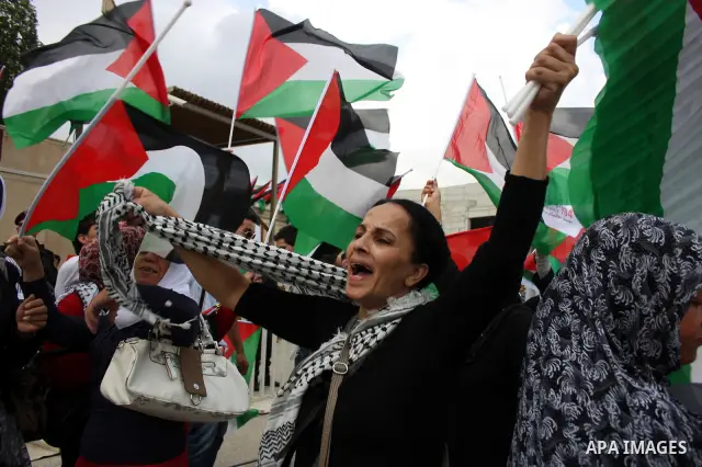 Thousands of cheering Palestinians welcome their president Mahmud Abbas outside his Ramallah headquarters on Sept. 25, 2011, as he returned from delivering a historic UN membership bid. Photo by Issam Rimawi