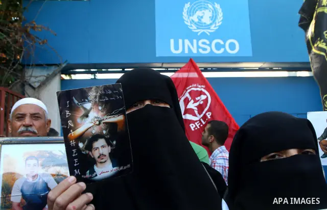 Palestinian women hold pictures of their prisoned relatives in Israeli jails infront of the UNSCO headquarters in Gaza City on Sep. 26, 2011. About 7000 prisoners are in Israeli jails according to the Palestinian prisone...