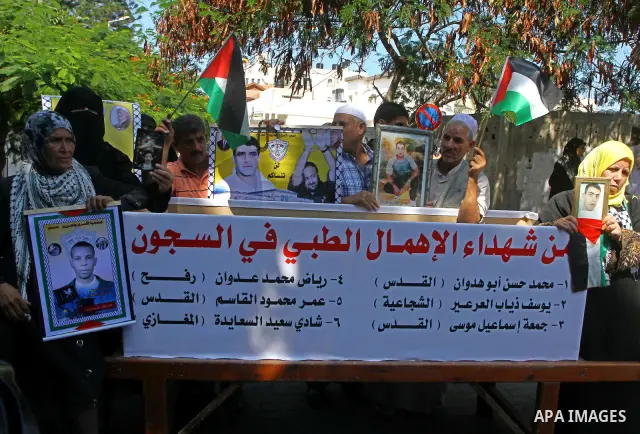 Palestinian women hold pictures of their prisoned relatives in Israeli jails infront of the UNSCO headquarters in Gaza City on Sep. 26, 2011. About 7000 prisoners are in Israeli jails according to the Palestinian prisone...