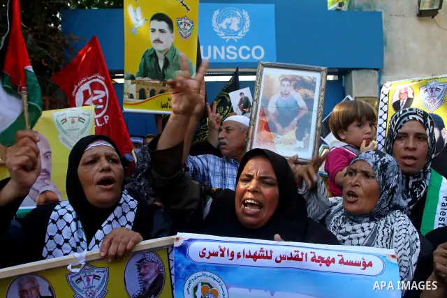Palestinian women hold pictures of their prisoned relatives in Israeli jails infront of the UNSCO headquarters in Gaza City on Sep. 26, 2011. About 7000 prisoners are in Israeli jails according to the Palestinian prisone...