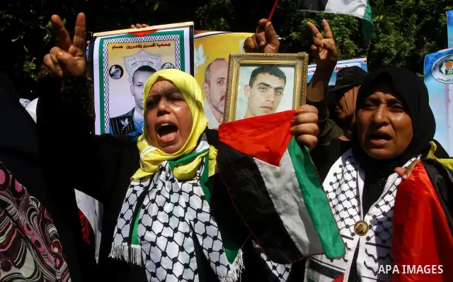 Palestinian women hold pictures of their prisoned relatives in Israeli jails infront of the UNSCO headquarters in Gaza City on Sep. 26, 2011. About 7000 prisoners are in Israeli jails according to the Palestinian prisone...