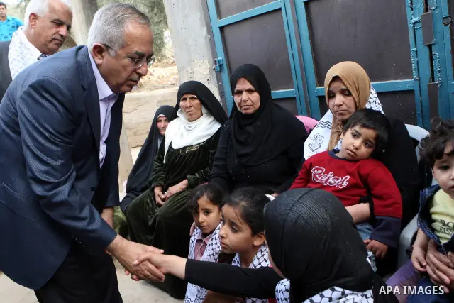 Palestinian Prime Minister, Salam Fayyad visits the family of the killed farmer Issam Badran who shot dead by Israeli troops in clashes which erupted after settlers attacked his village, in the West Bank village of Qusra...