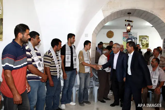 Palestinian Prime Minister, Salam Fayyad visits the family of the killed farmer Issam Badran who shot dead by Israeli troops in clashes which erupted after settlers attacked his village, in the West Bank village of Qusra...