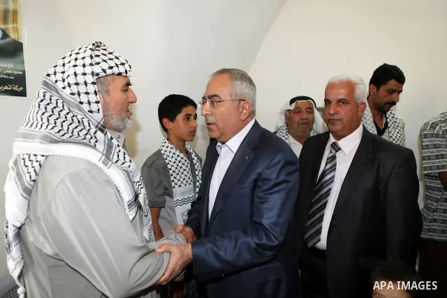 Palestinian Prime Minister, Salam Fayyad visits the family of the killed farmer Issam Badran who shot dead by Israeli troops in clashes which erupted after settlers attacked his village, in the West Bank village of Qusra...