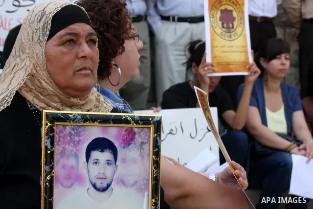 Relatives of Palestinians held in Israeli jails demonstrate in front of the Red Cross headquarters in Ramallah in support of the prisoners' first day of hunger strike on Sep. 28, 2011. Photo by Issam Rimawi
