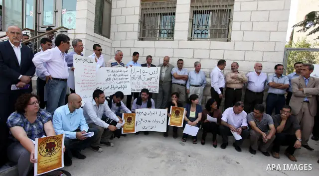 Relatives of Palestinians held in Israeli jails demonstrate in front of the Red Cross headquarters in Ramallah in support of the prisoners' first day of hunger strike on Sep. 28, 2011. Photo by Issam Rimawi