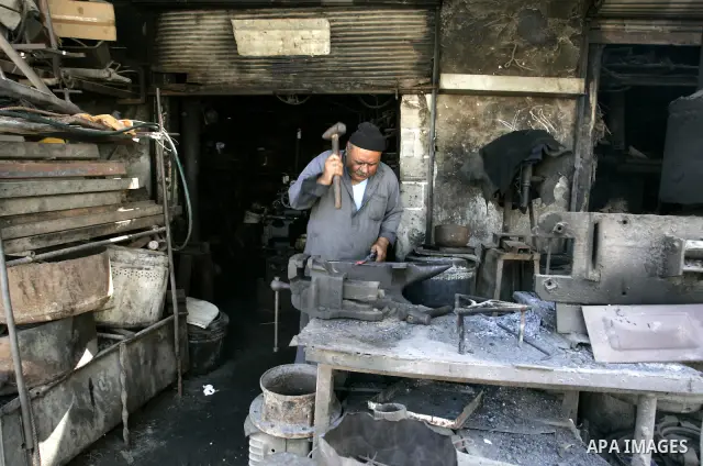 A Palestinian man works at a metal workshop in Rafah, southern Gaza Strip on Sept 28, 2011. An Israeli cabinet minister urged the government to accept a Quartet proposal for an immediate renewal of talks with the Palesti...