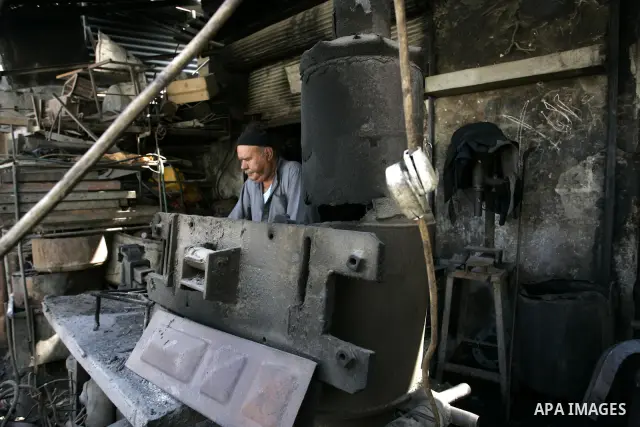 A Palestinian man works at a metal workshop in Rafah, southern Gaza Strip on Sept 28, 2011. An Israeli cabinet minister urged the government to accept a Quartet proposal for an immediate renewal of talks with the Palesti...