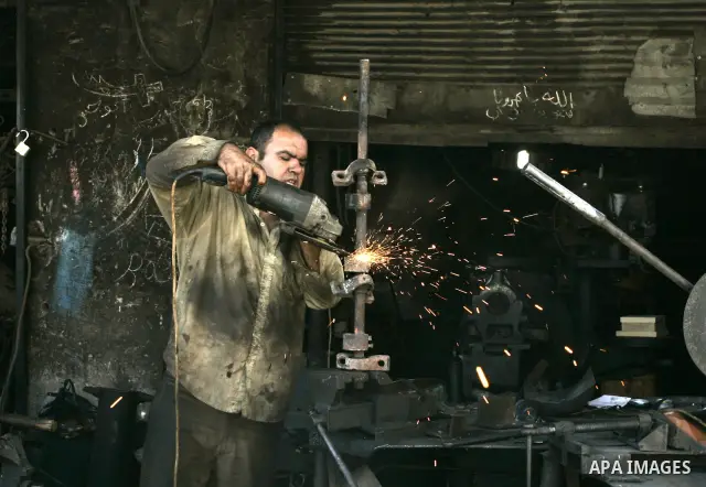 A Palestinian man works at a metal workshop in Rafah, southern Gaza Strip on Sept 28, 2011. An Israeli cabinet minister urged the government to accept a Quartet proposal for an immediate renewal of talks with the Palesti...