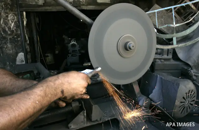 A Palestinian man works at a metal workshop in Rafah, southern Gaza Strip on Sept 28, 2011. An Israeli cabinet minister urged the government to accept a Quartet proposal for an immediate renewal of talks with the Palesti...