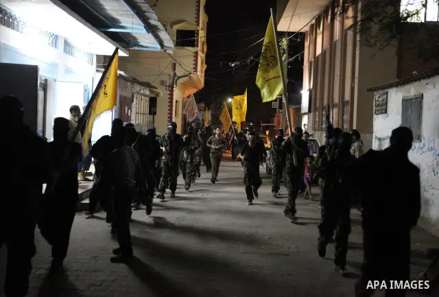 Palestinian militants of the Nabil Massud Unit of the Al-Aqsa Martyrs Brigades, an armed offshoot of the Fatah movement, march in the Jabalia refugee camp in the northern Gaza Strip on Sept. 28, 2011 as they mark the 11t...
