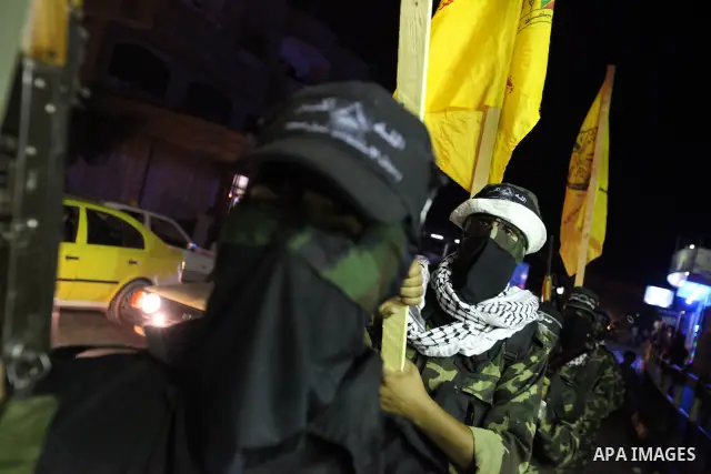 Palestinian militants of the Nabil Massud Unit of the Al-Aqsa Martyrs Brigades, an armed offshoot of the Fatah movement, march in the Jabalia refugee camp in the northern Gaza Strip on Sept. 28, 2011 as they mark the 11t...