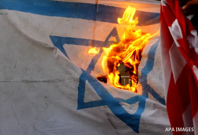 Palestinian militants of Popular Resistance Committees burn an Israeli and American flags during a rally to mark the 12th anniversary of Al-Aqsa Intifada (uprising) in Gaza city on Sept. 29,2011. Israel on Tuesday approv...