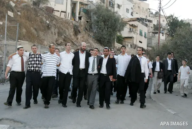 Jews gather to read prayers and perform 'Tashlich,' meaning to 'cast off,' near a small stream of water overlooking the arab East Jerusalem village of Silwan, at sun down on the first day of Jewish New Year, or Rosh Hash...
