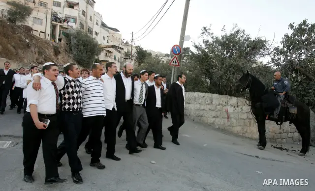 Jews gather to read prayers and perform 'Tashlich,' meaning to 'cast off,' near a small stream of water overlooking the arab East Jerusalem village of Silwan, at sun down on the first day of Jewish New Year, or Rosh Hash...