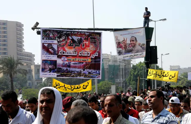 Egyptian demonstrators hold banners during a protest at Tahrir Square in Cairo, Egypt, Friday, Sept. 30, 2011. Several thousand Egyptians are protesting against the country's military ruler's decision to retain the much...