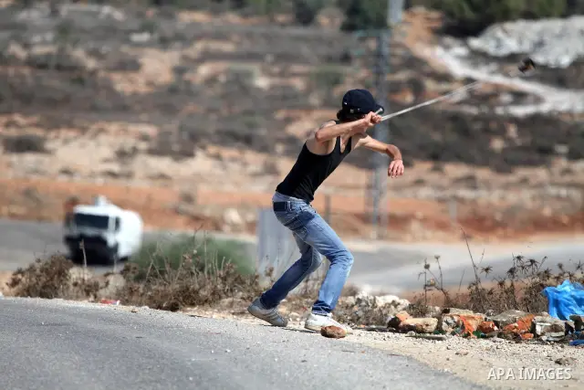Palestinian youths clash with Israeli forces following a weekly demonstration against Israeli settlement expansion, in the West Bank village of Nabi Saleh, near the Jewish settlement of Halamish on September 30, 2011. Ph...