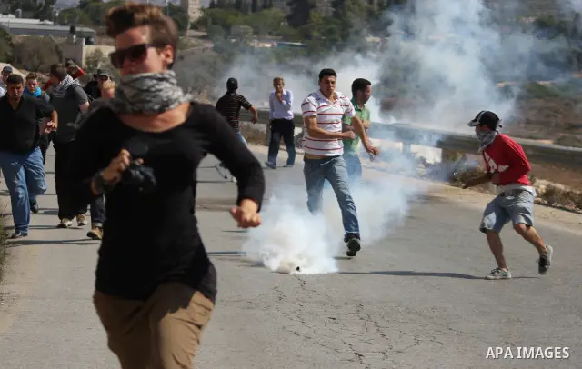 Palestinian youths clash with Israeli forces following a weekly demonstration against Israeli settlement expansion, in the West Bank village of Nabi Saleh, near the Jewish settlement of Halamish on September 30, 2011. Ph...