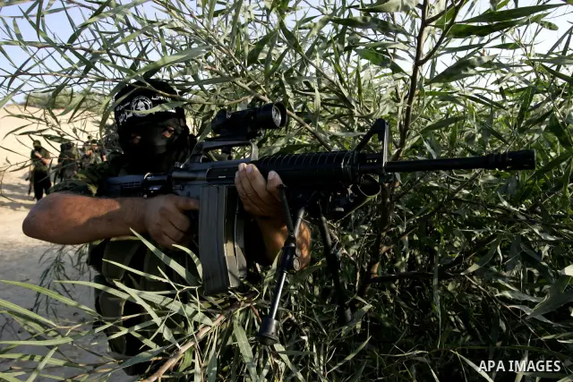 Palestinian militants from the Popular Resistance Movement participate in a training session in the southern Gaza Strip town of Khan Younis on Sept.30,2011. Israel on Tuesday approved construction of 1,100 homes for Jews...